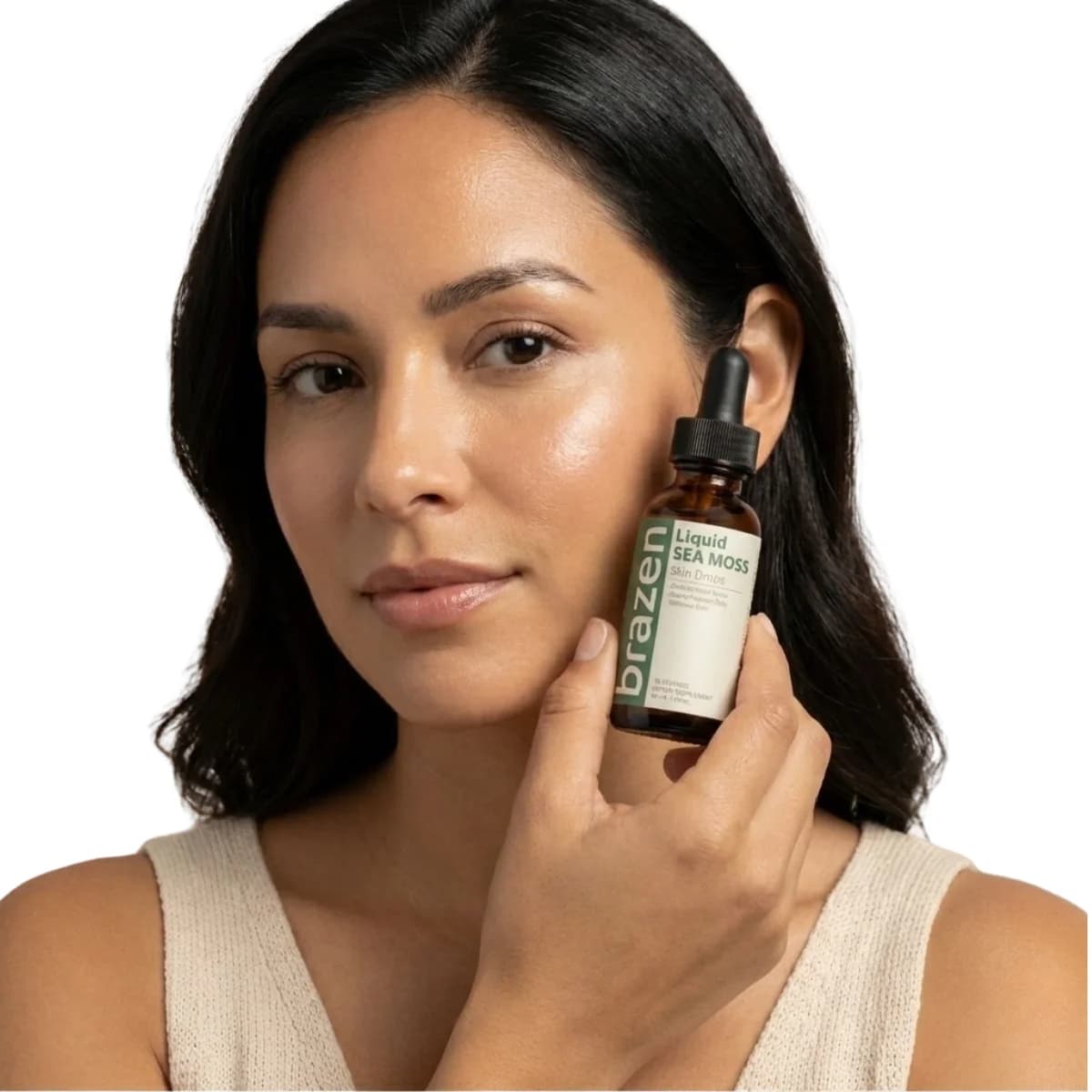 Close-up of a woman holding Brazen Sea Moss Skin Drops beside her face