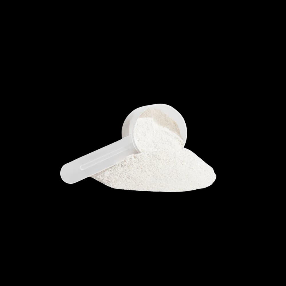 Scoop of Brazen vanilla collagen creamer powder spilling onto a white surface