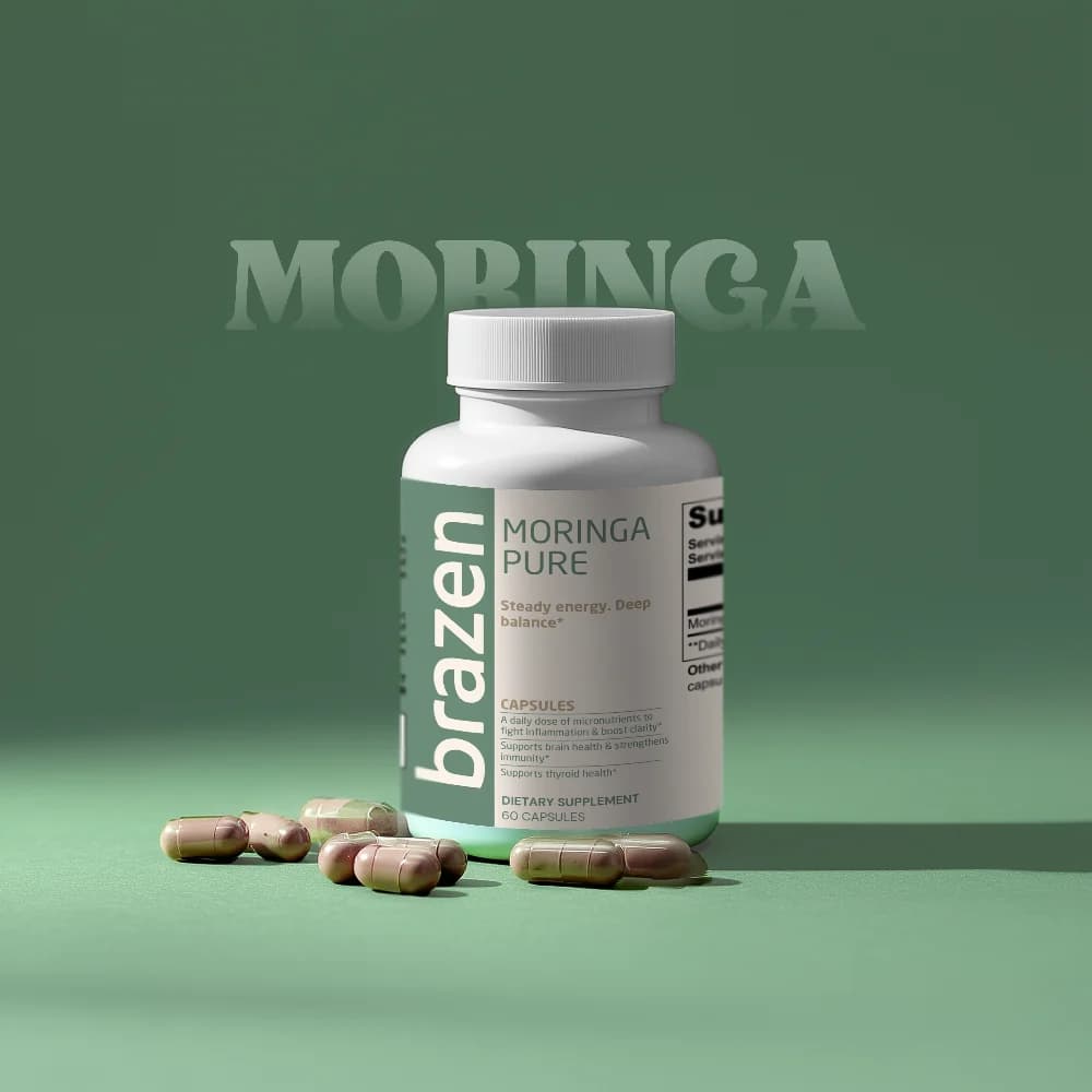 Bottle of Brazen Moringa Pure with capsules scattered in front, on a green background